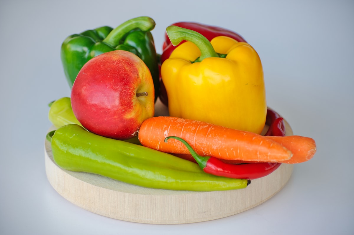 Colorful vegetables and whole foods on a wooden table